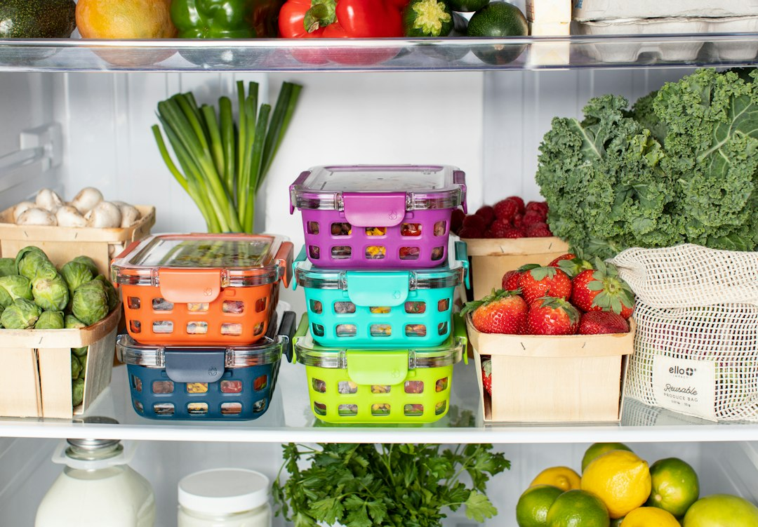 Colorful reusable food-storage containers arranged in a refrigerator